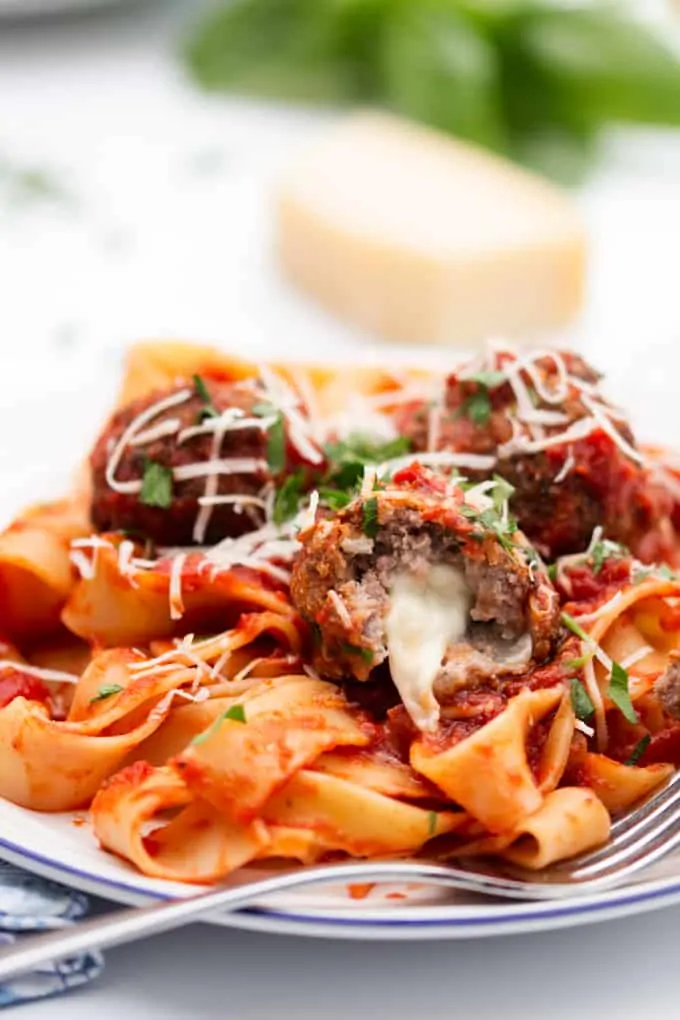 meatballs stuffed with oozy mozzarella with a rich tomato sauce and pappardelle pasta