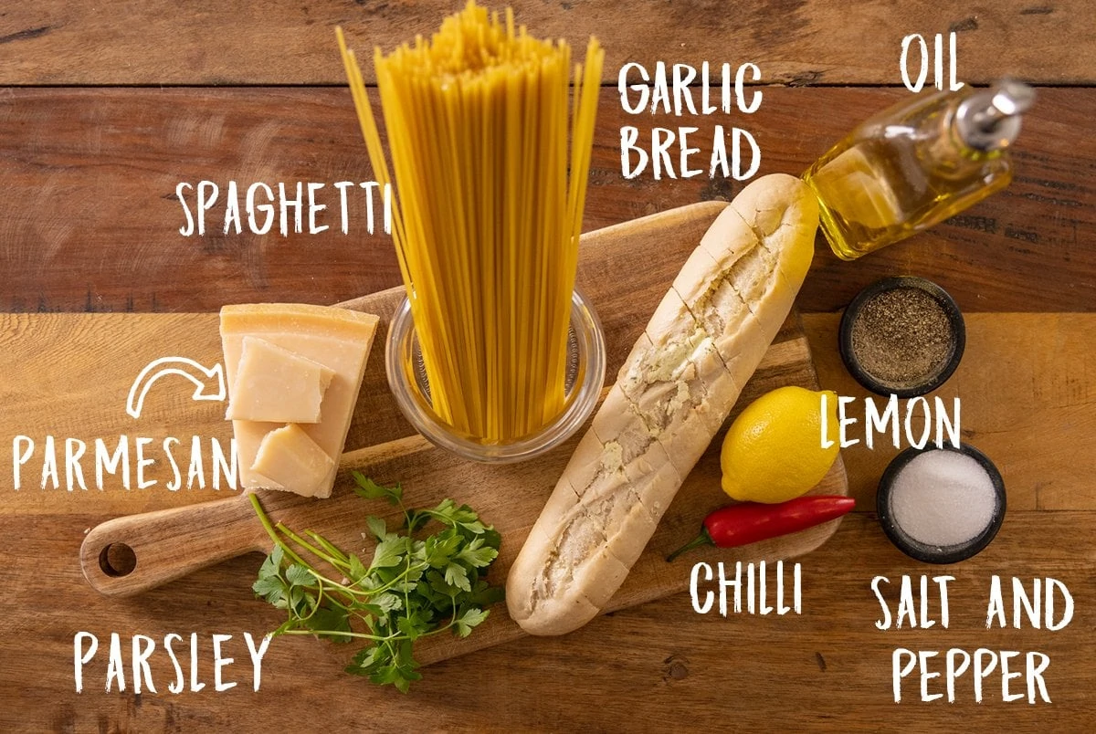 Ingredients for garlic bread spaghetti on a wooden table
