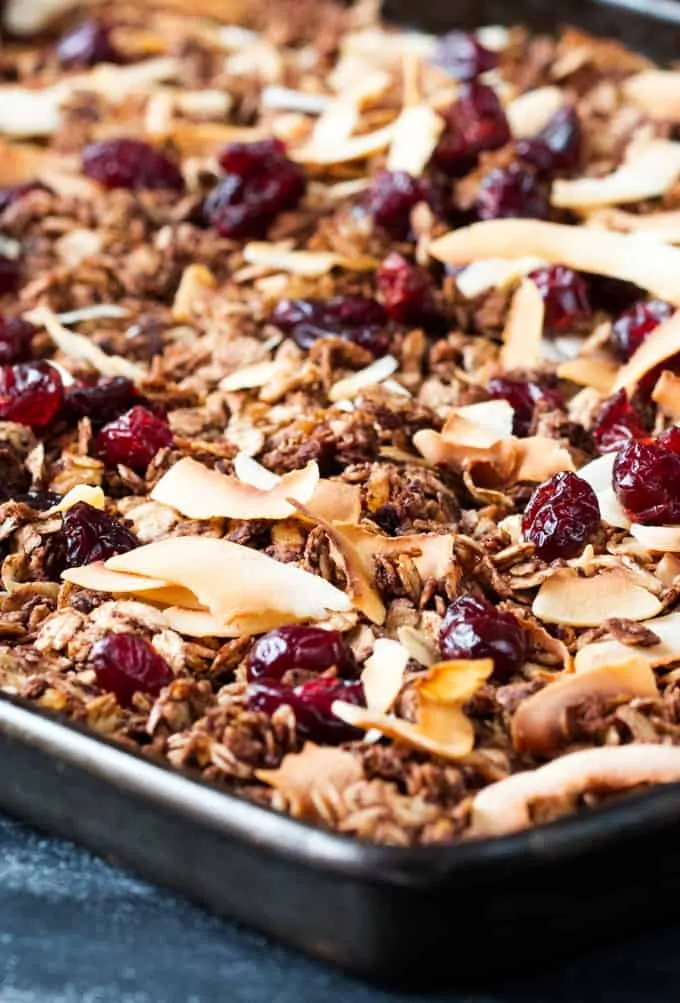 Chocolate coconut granola with cranberries in a baking tray