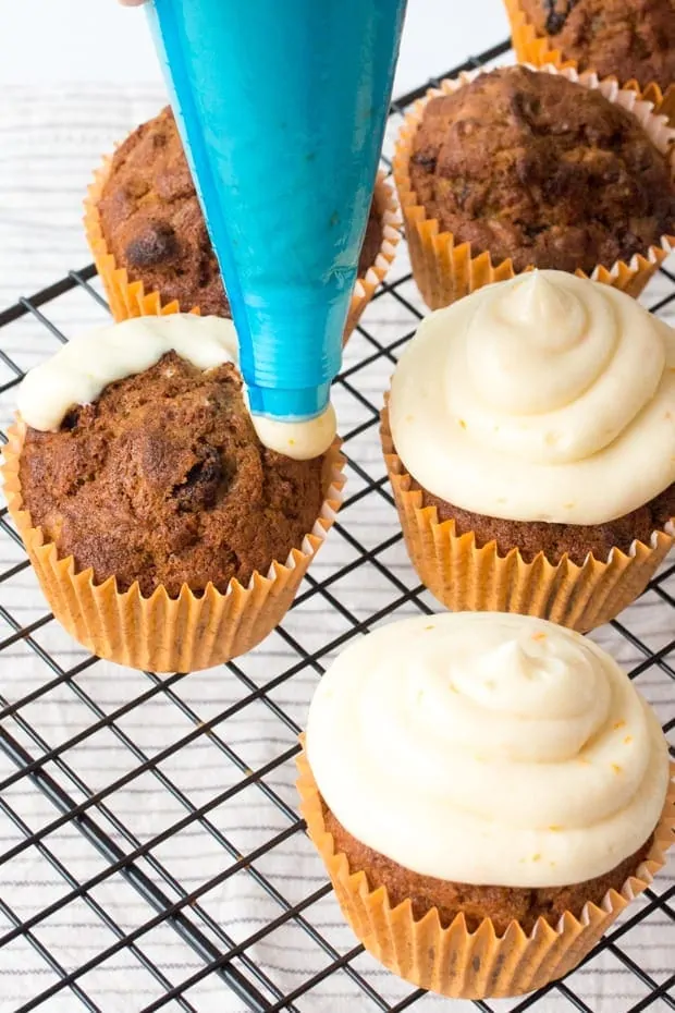 Moist and fluffy carrot & orange cupcakes with a hint of spice and lots of juicy raisins. All topped off with a zesty cream cheese frosting and orange wedges.