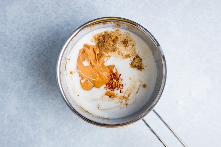 Ingredients for Thai peanut sauce in a pan