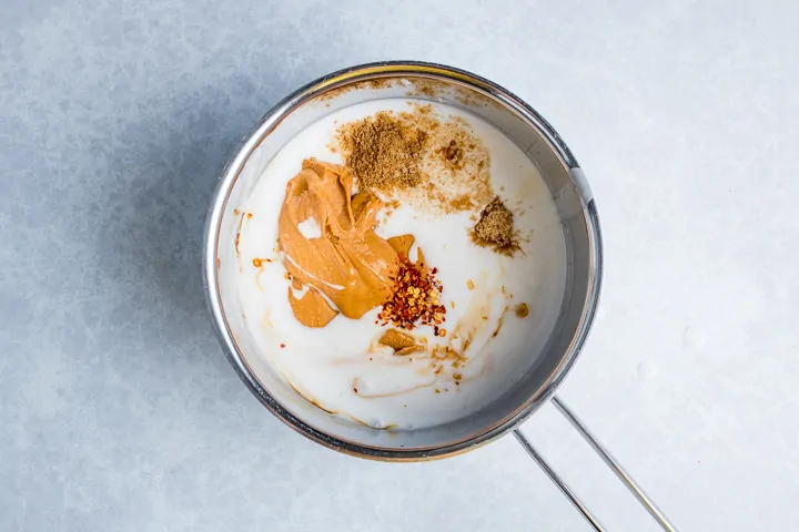 Ingredients for Thai peanut sauce in a pan