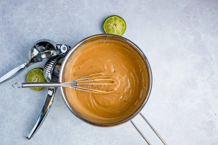 Thai satay sauce in a pan on a light background