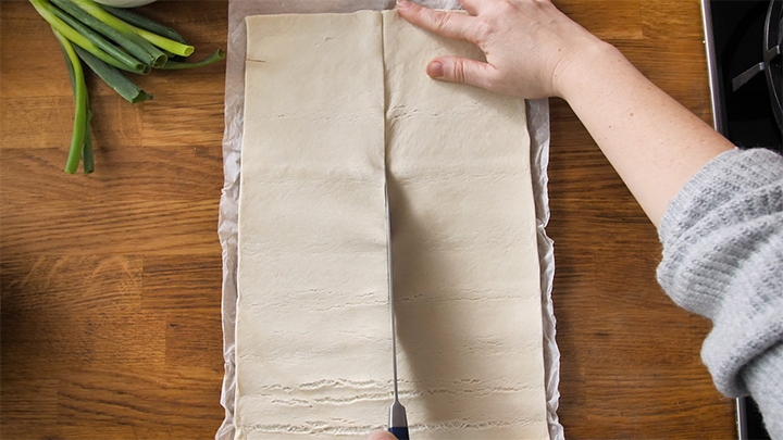 Sheet of pastry being cut in half