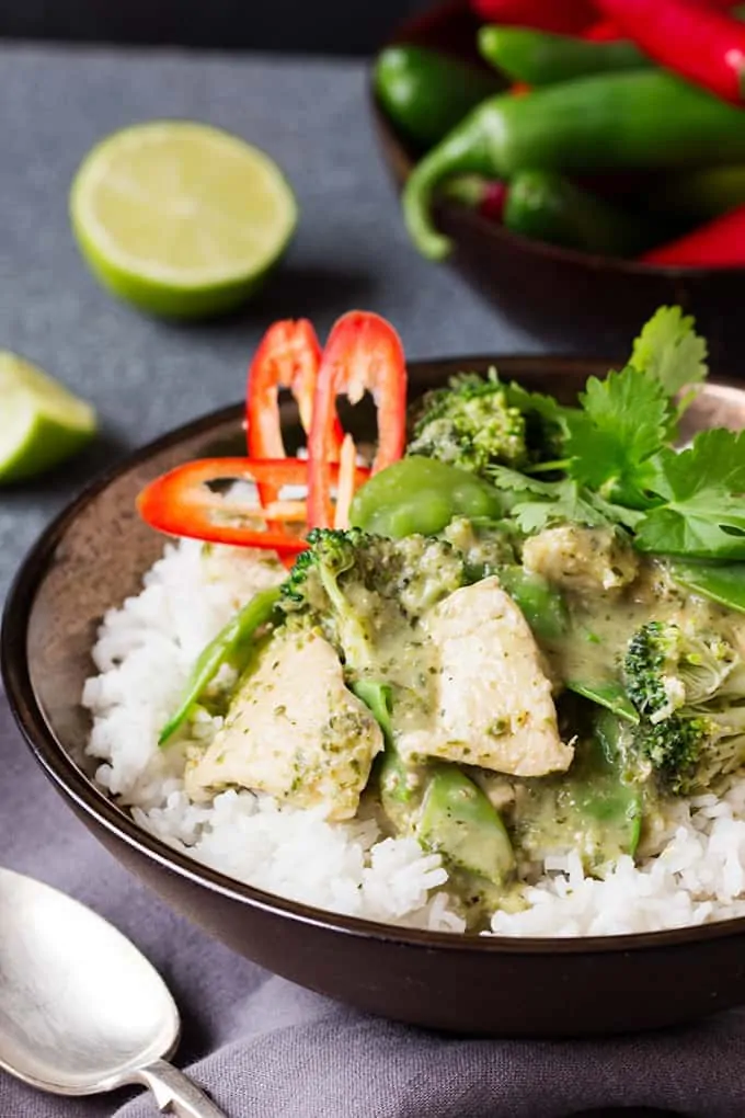 Skinny Thai Green Curry on a bed of rice in a bowl with chillis in the background