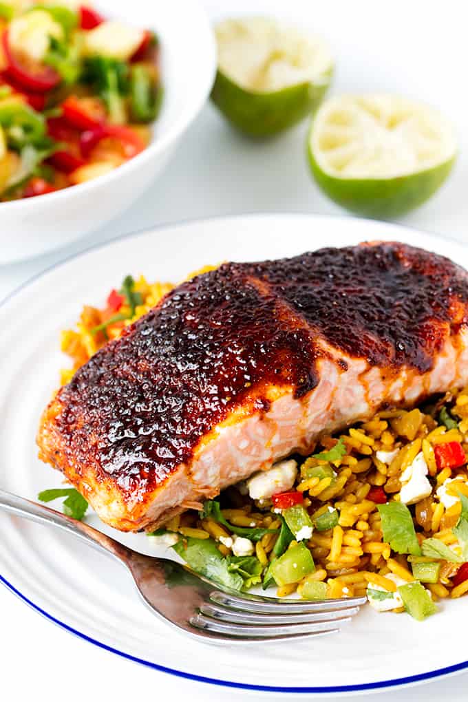Spiced caramelised salmon served on a bed of savoury rice with feta and veggies. Colourful, healthy and delicious!
