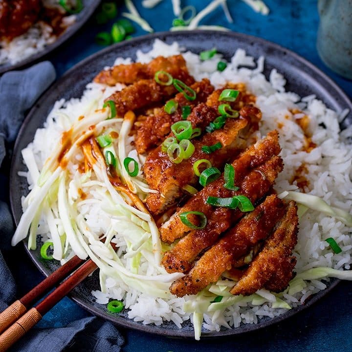 Tonkatsu pork curry on a plate with rice and cabbage