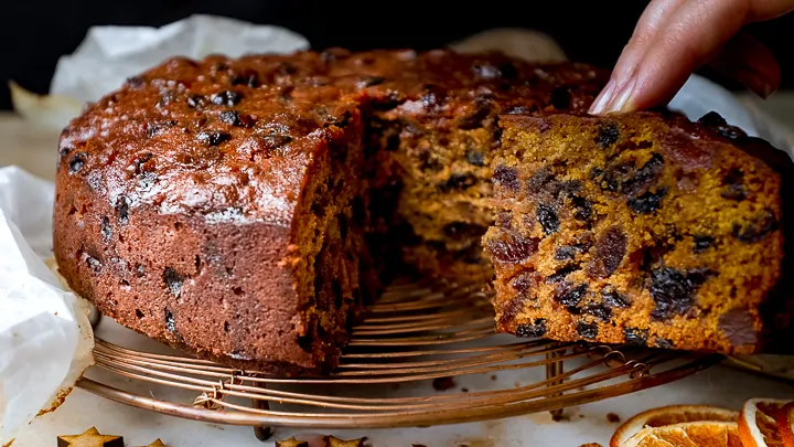 Slice being taken out of a rich fruit cake