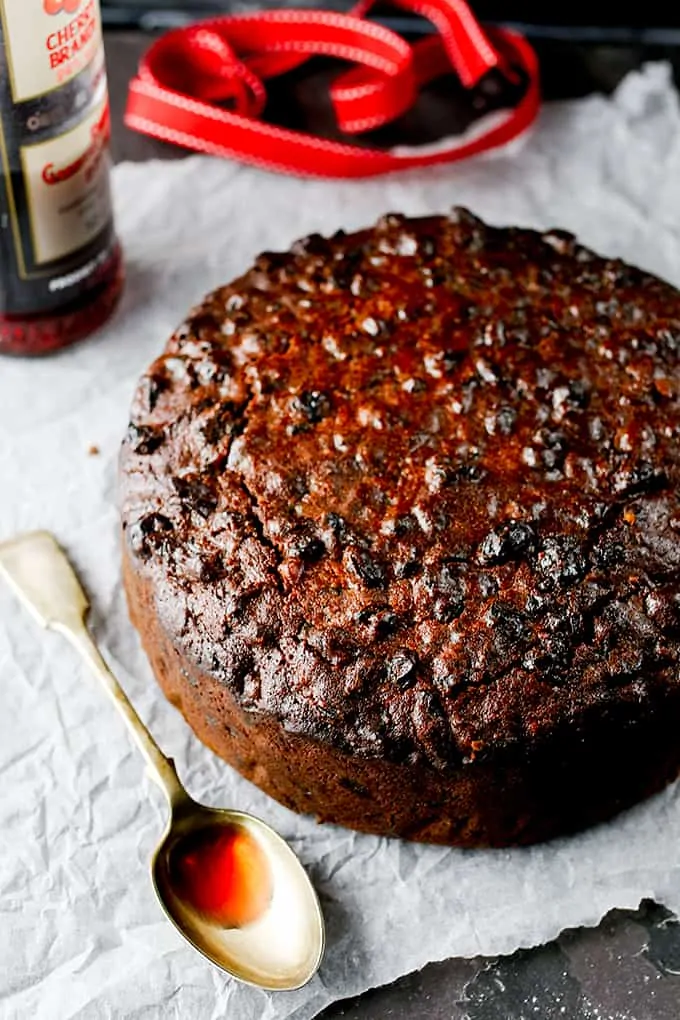 Cherry brandy being spooned onto the best Christmas cake.