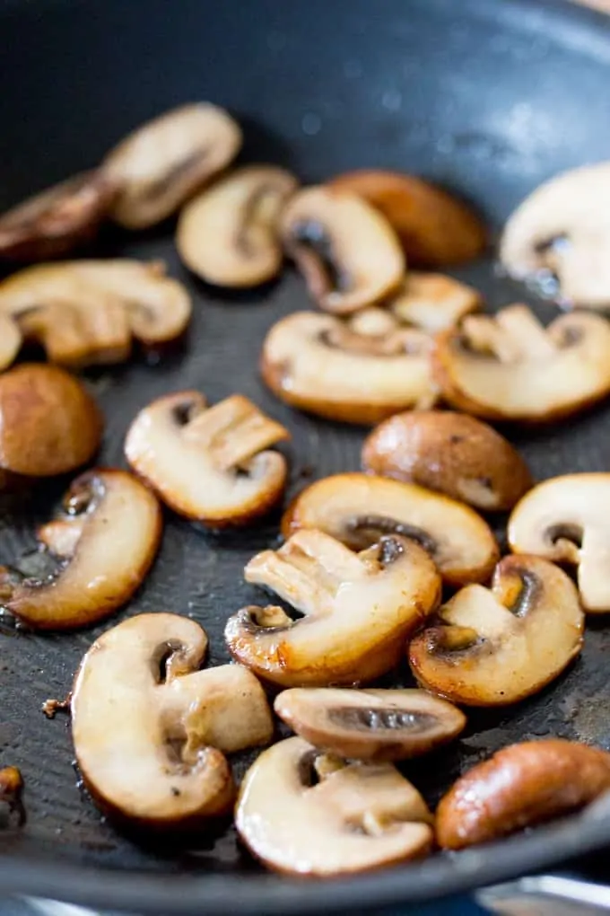 mushrooms cooking in a pan