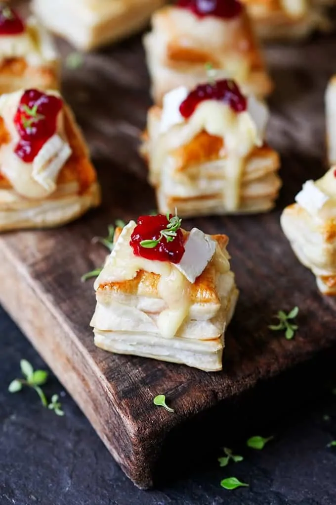 Cranberry and Brie bites close up on a wooden board