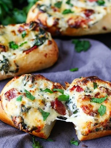 These stuffed cheesy breads with spinach and bacon use part-baked petit pans that cook at the same time as the gooey filling. Perfect for game day!!