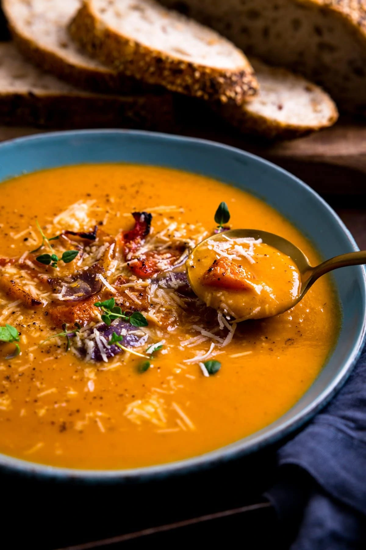 Spoonful being taken from a bowl of Roasted vegetable soup