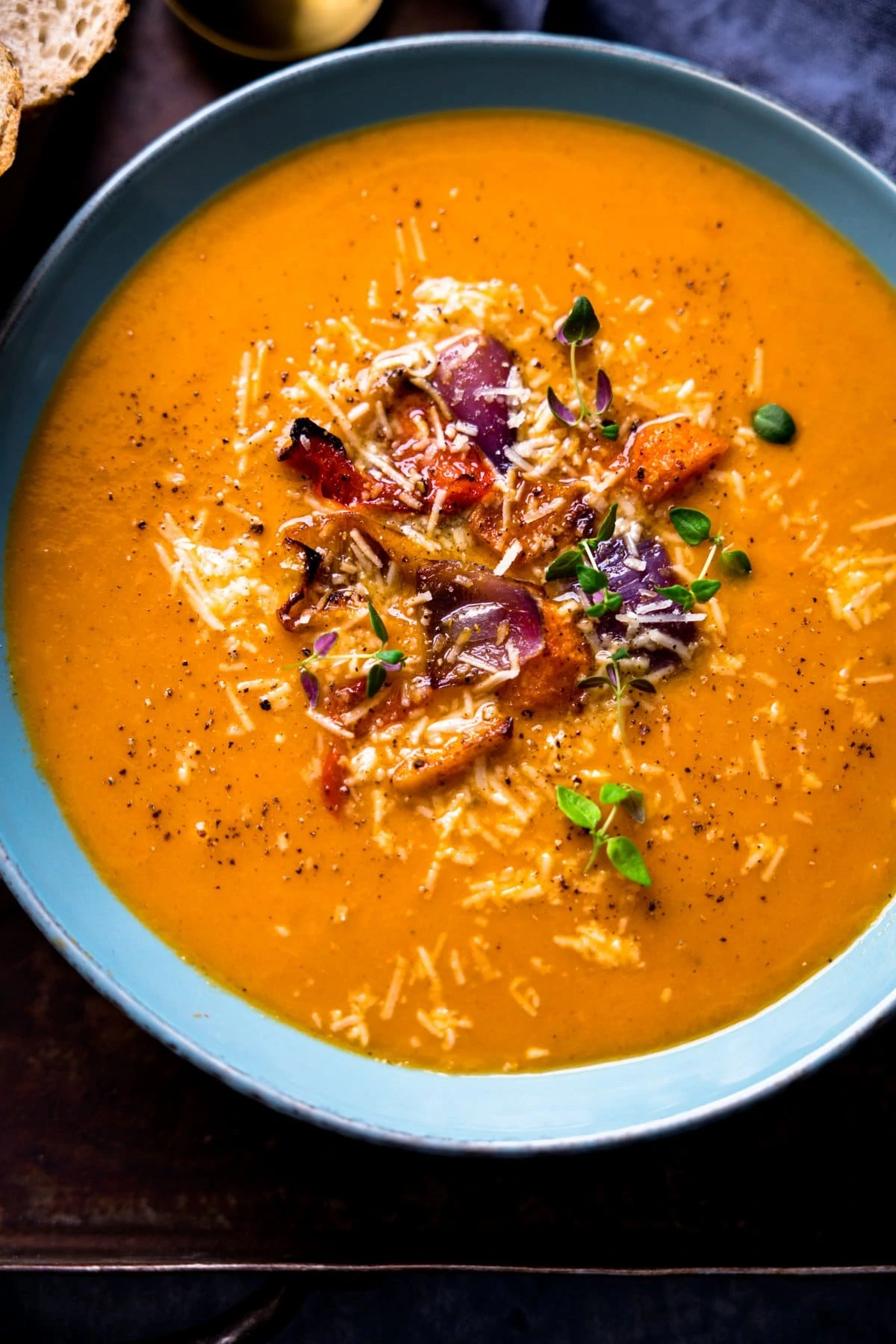 Overhead image of a blue bowl filled with Roasted vegetable soup