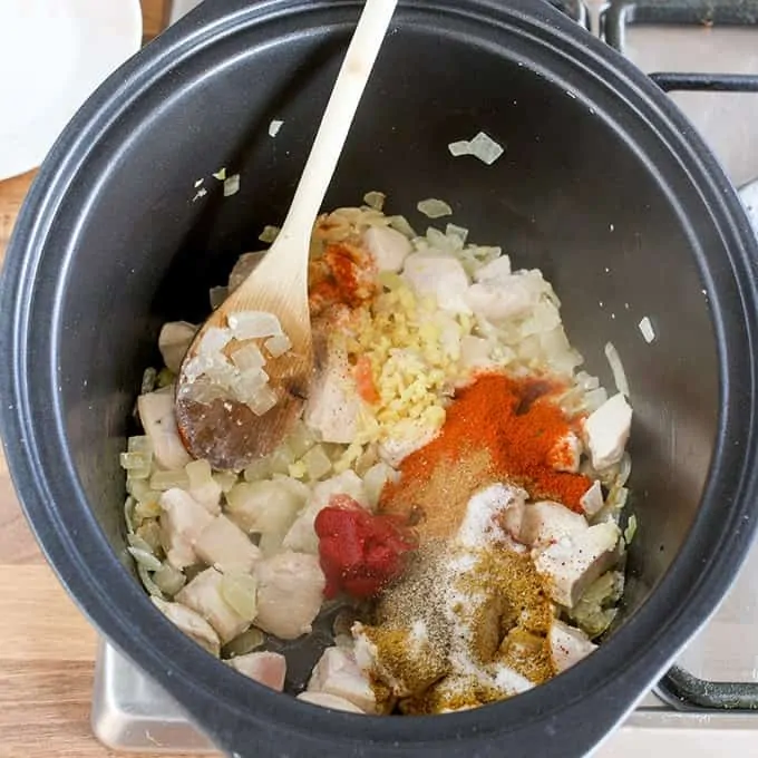 Chicken, onions and spices cooking in a pan for a chicken curry