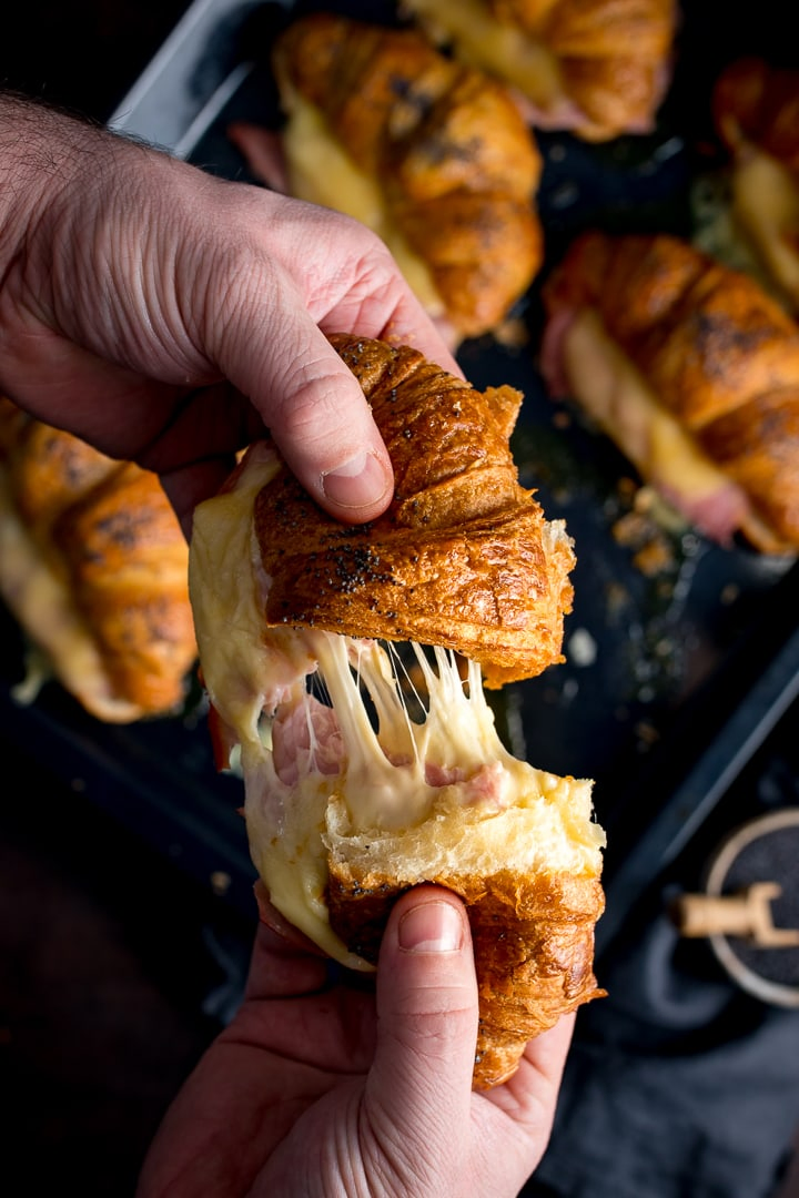 ham and cheese croissant being pulled apart