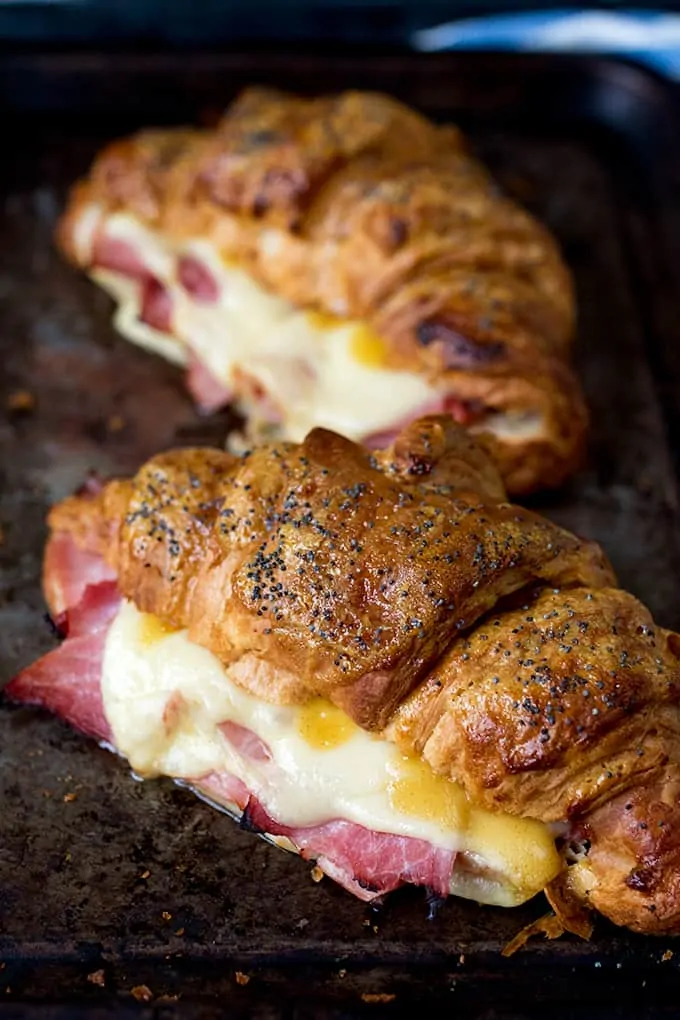 two Ham and Cheese Croissant with Honey Mustard Glaze on a metal tray