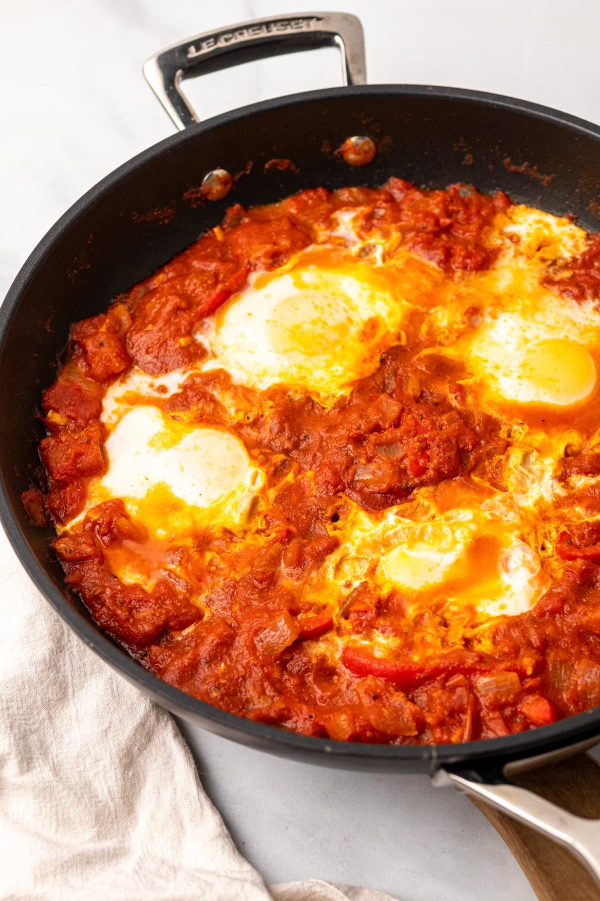 Shakshuka in a pan on a light background.