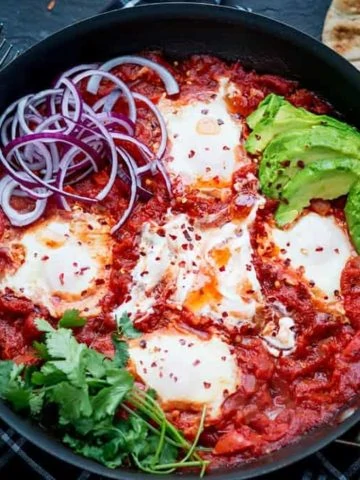 Mexican Shakshuka - dippy eggs poached in a rich Cajun tomato sauce.