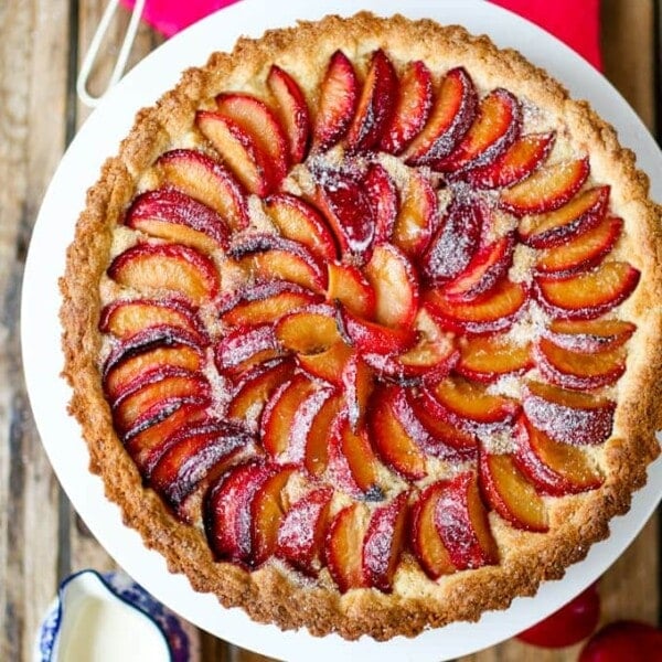 A fruit plum tart with almond frangipane and crumbly sweet pastry.