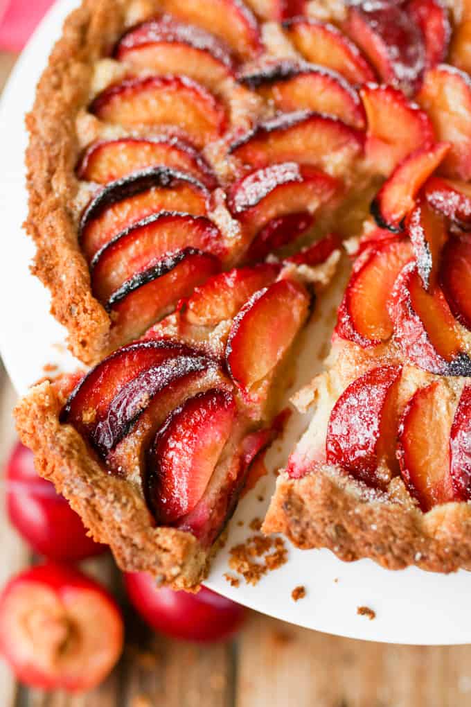 A fruit plum tart with almond frangipane and crumbly sweet pastry.