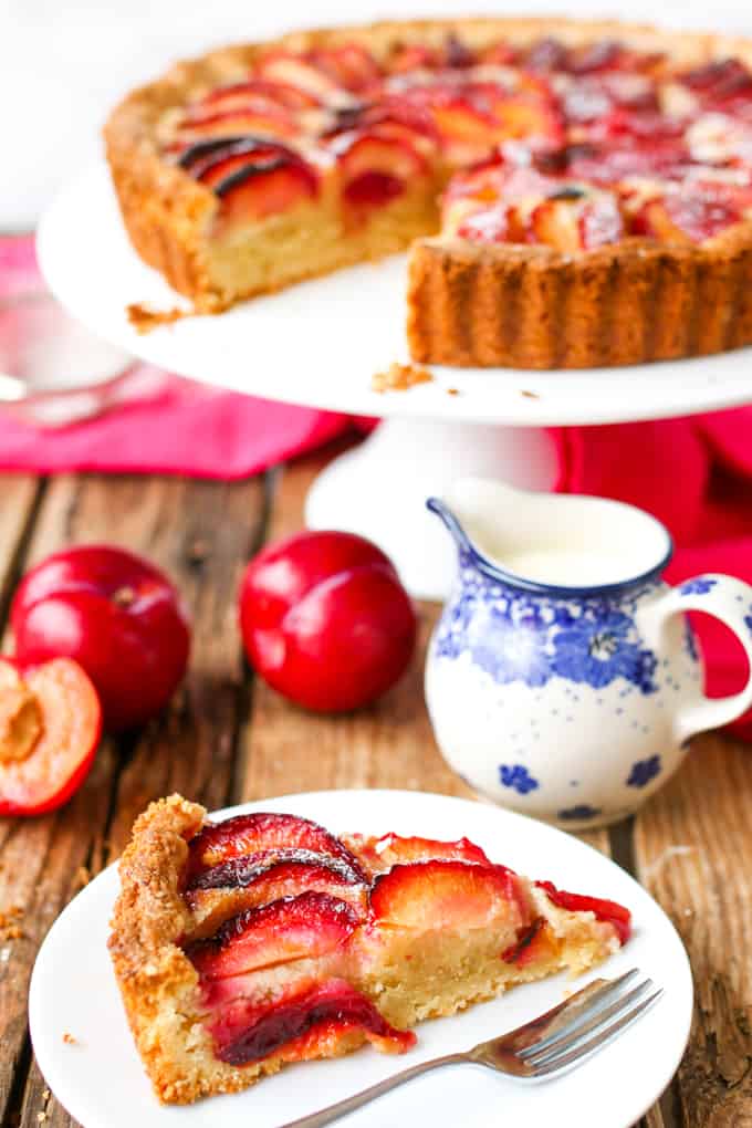 A fruit plum tart with almond frangipane and crumbly sweet pastry.