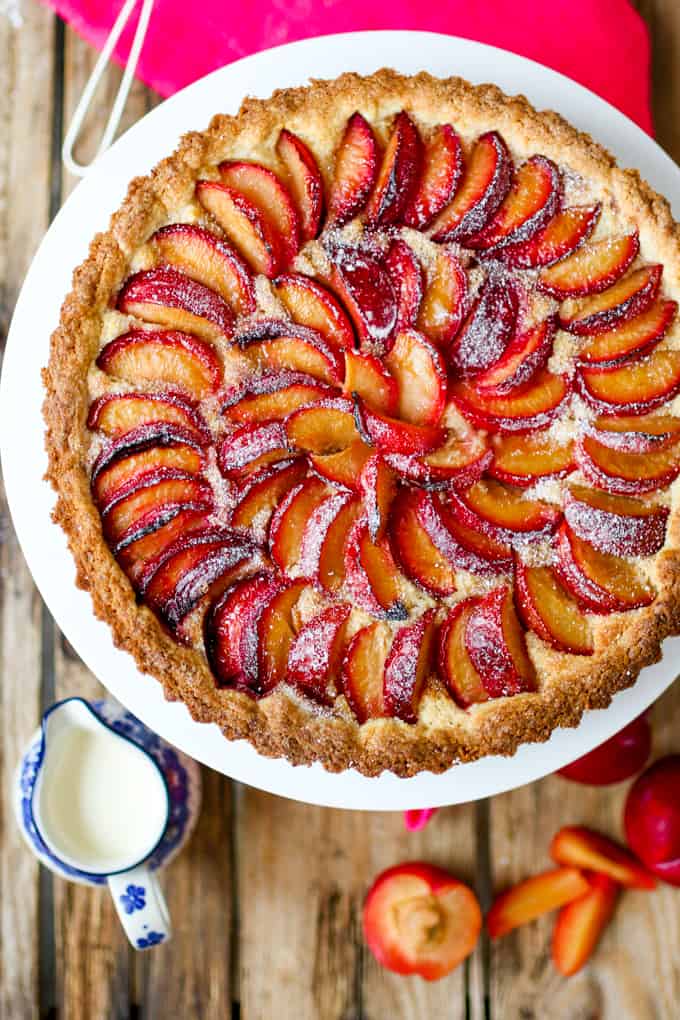 A fruit plum tart with almond frangipane and crumbly sweet pastry.