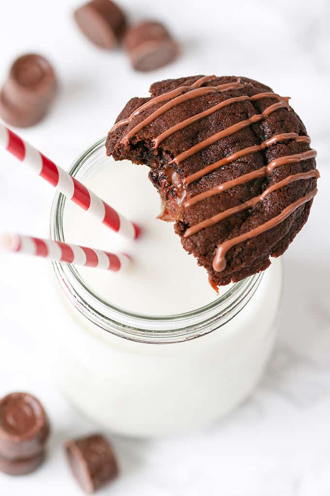Gooey Rolo Stuffed Cookies with a glass of milk.
