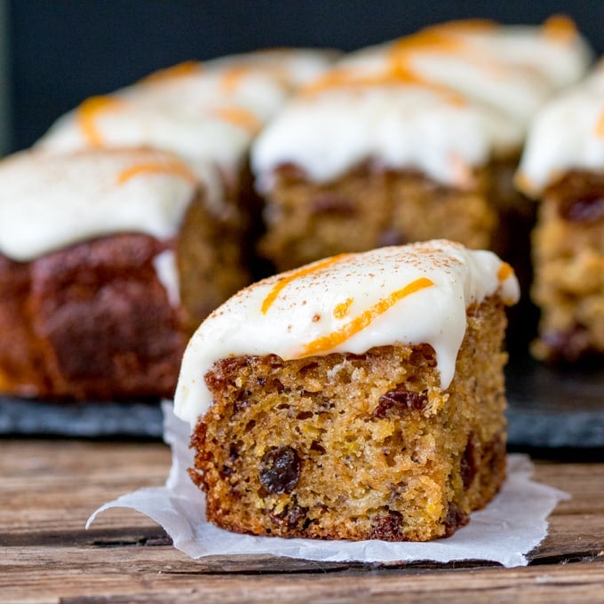 A fluffy moist carrot tray bake with orange infused raisins and zesty cream cheese frosting!