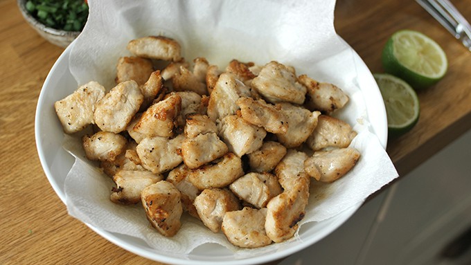 Fried chicken pieces in a bowl lined with kitchen paper