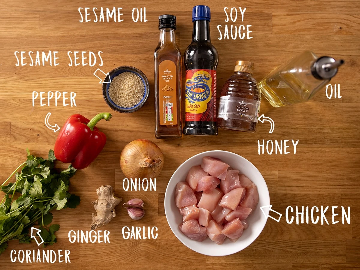Ingredients for honey garlic chicken skewers on a wooden table