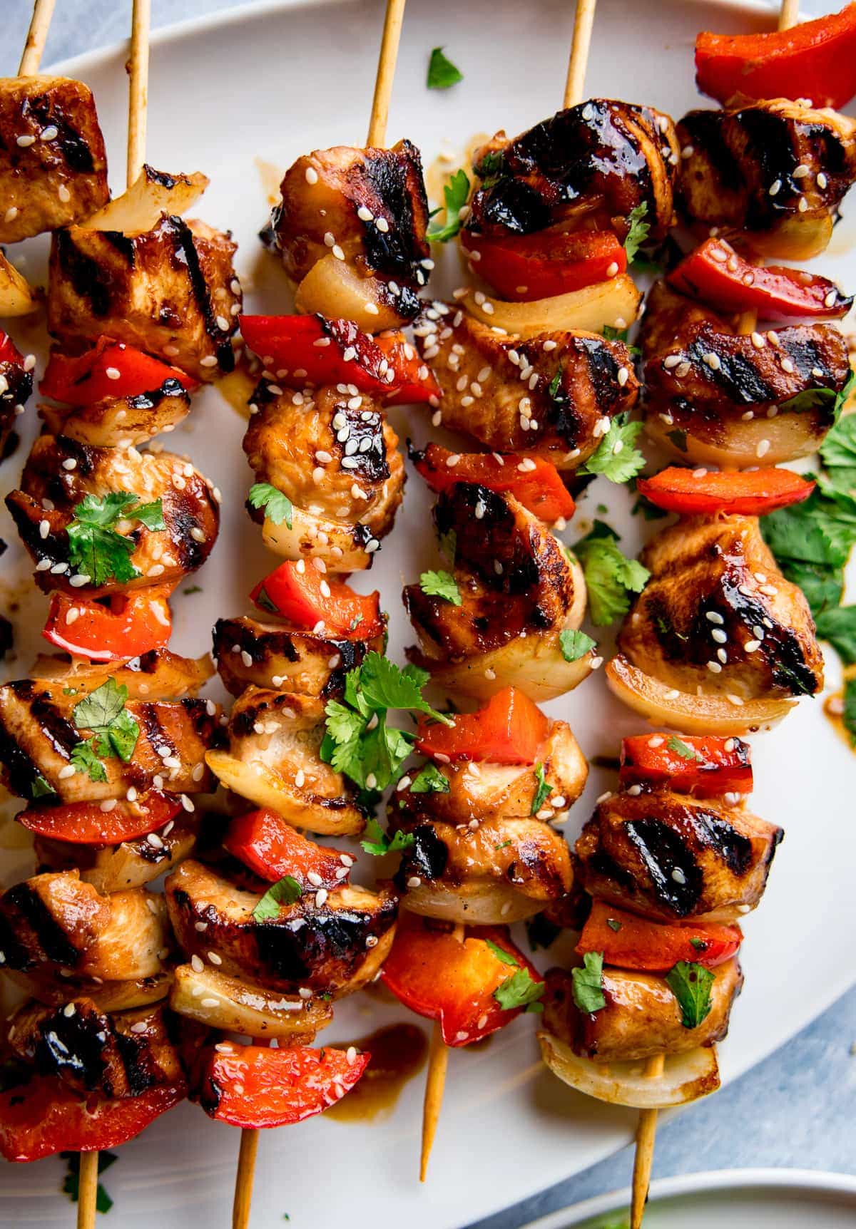 honey garlic chicken skewers with sesame seeds on top