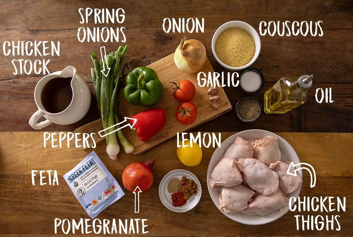 Ingredients for one-pot chicken and couscous on a wooden table