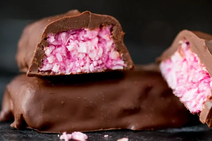 Raspberry Ruffle Bars - A vibrant coconut raspberry snack bar, covered in rich, dark chocolate.