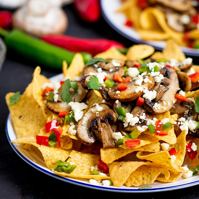 Super quick Nachos topped with garlic mushrooms, chilies and crumbly Lancashire cheese! A great vegetarian appetizer or party dish!
