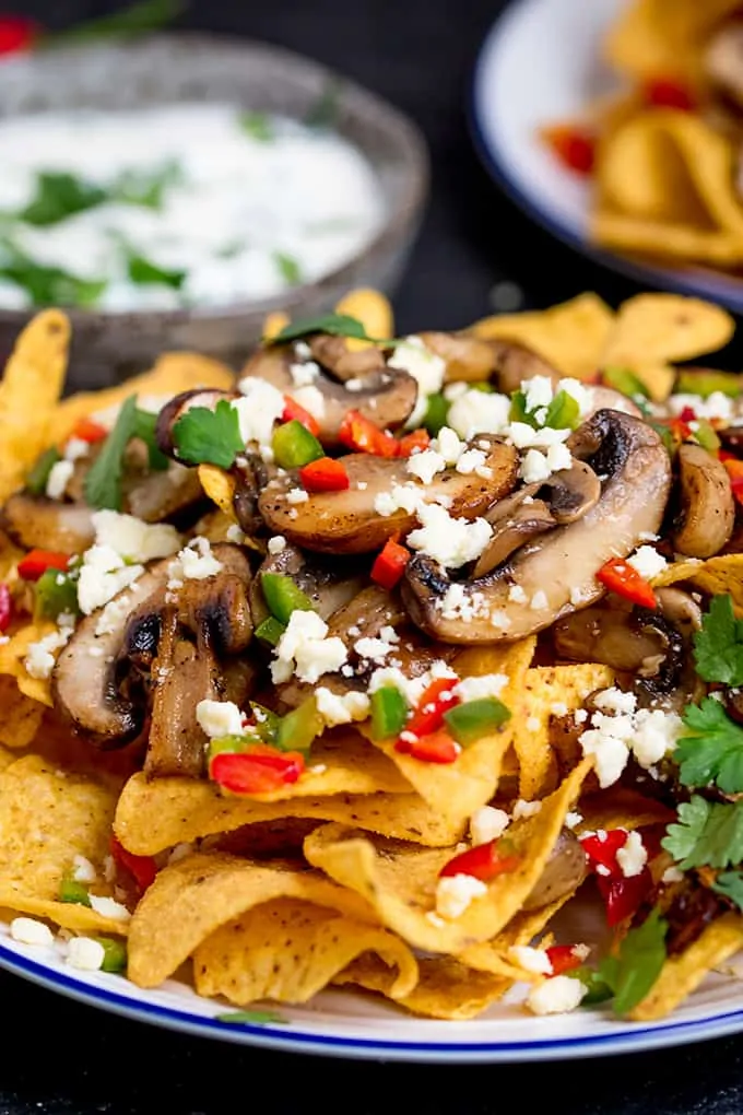 Super quick Nachos topped with garlic mushrooms, chilies and crumbly Lancashire cheese! A great vegetarian appetizer or party dish!