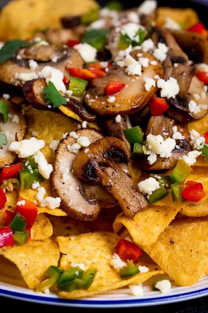 Super quick Nachos topped with garlic mushrooms, chilies and crumbly Lancashire cheese! A great vegetarian appetizer or party dish!