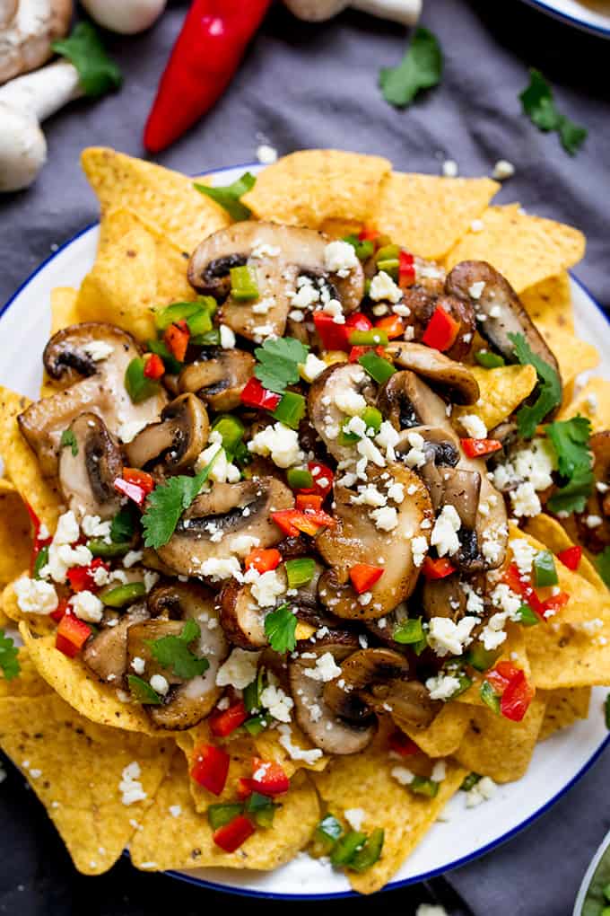 Super quick Nachos topped with garlic mushrooms, chilies and crumbly Lancashire cheese! A great vegetarian appetizer or party dish!