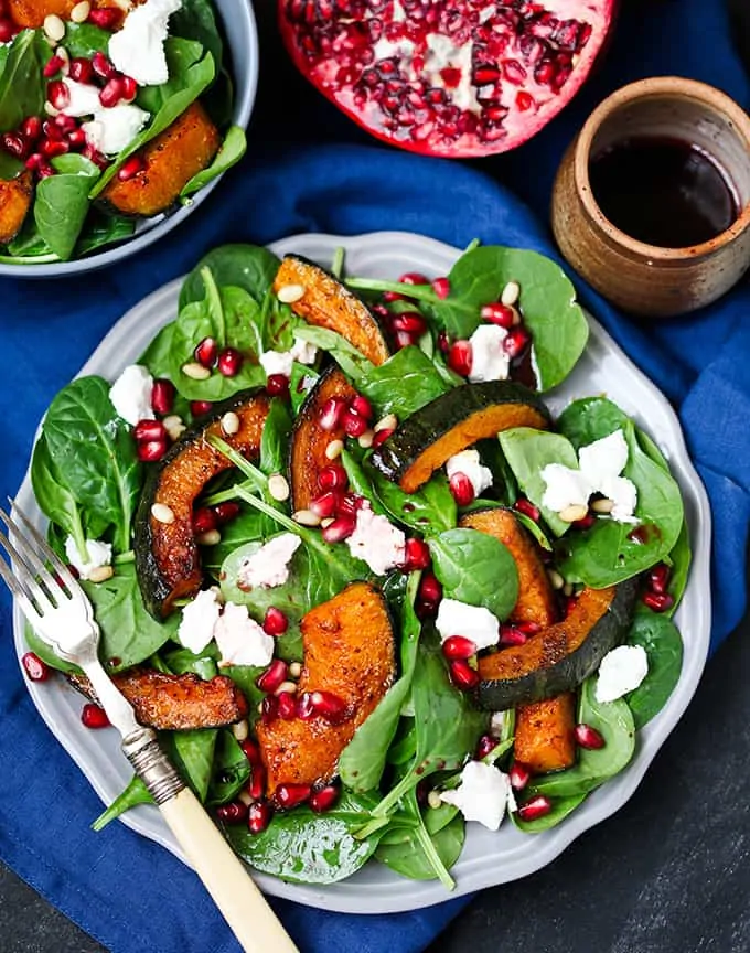 Sweet Roasted Kabocha Squash Salad - with creamy goat's cheese and a tangy pomegranate dressing. A deliciously filling dinner - perfect for Meatless Monday!