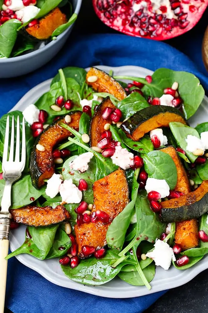 Sweet Roasted Kabocha Squash Salad - with creamy goat's cheese and a tangy pomegranate dressing. A deliciously filling dinner - perfect for Meatless Monday!