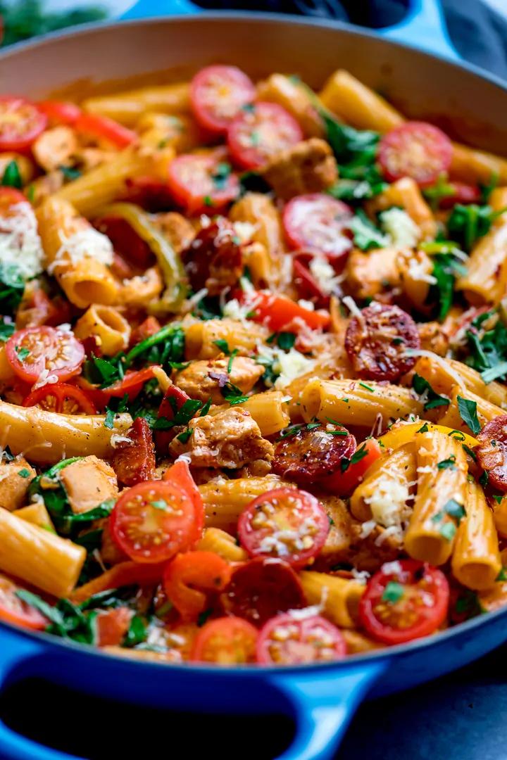 Close up of a blue pan containing Cajun chicken pasta