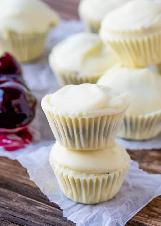 Bite sized creamy white chocolate cups filled with crushed biscuit and cherries - a simple 3-ingredient treat!