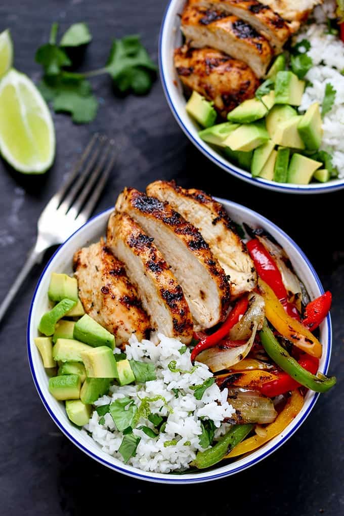 A bowl full of griddled Cajun chicken with charred veggies and coriander-lime rice