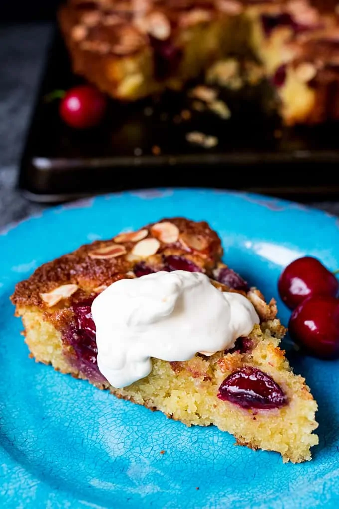 A fluffy Cherry and Almond Cake with fresh cherries and dollops of jam. So tasty and gluten free too!