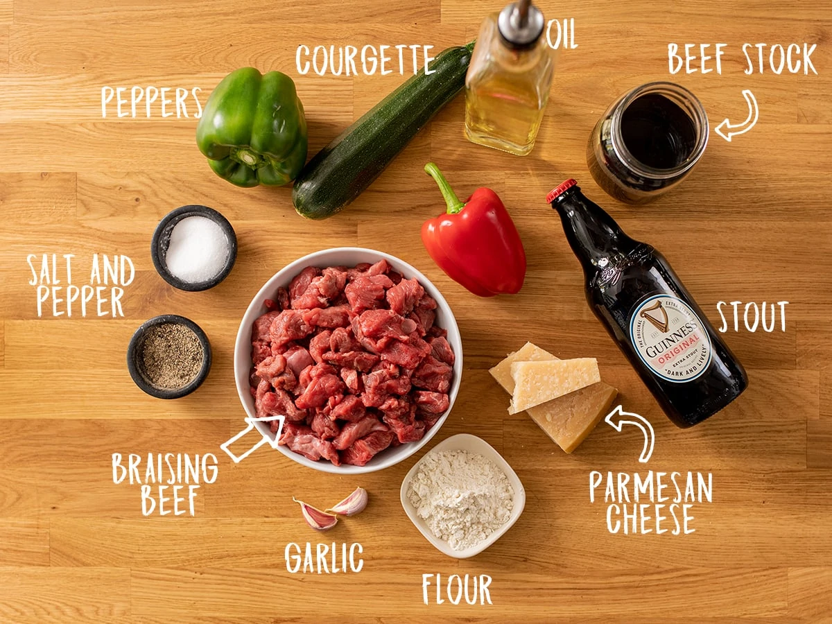 Ingredients to make summer beef casserole on a wooden table