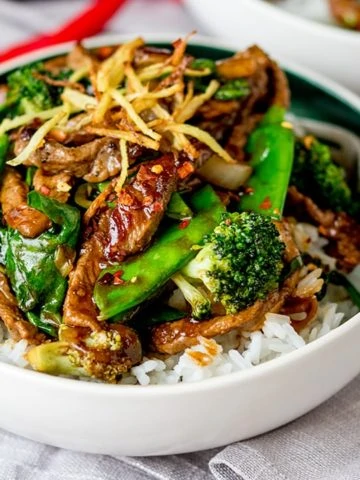 Ginger beef and broccoli in a bowl with rice