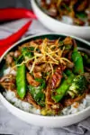 Ginger beef stir fry in a bowl with broccoli and rice