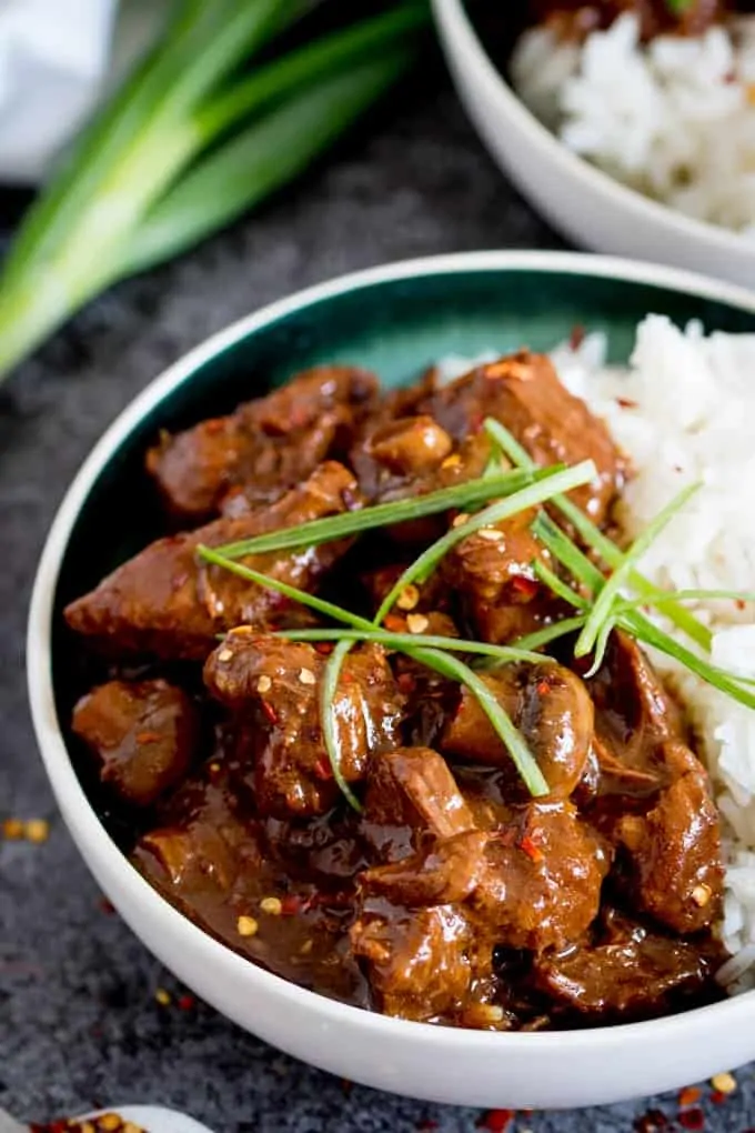 Chinese Beef in a bowl with rice and topped with spring onions