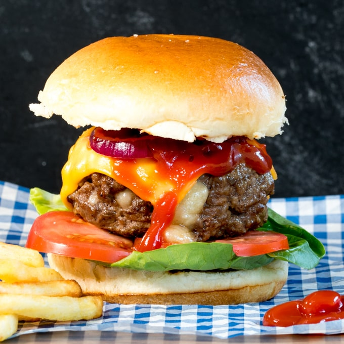 This melty cheese stuffed burger with with crunchy lettuce, onion and juicy tomatoes sandwiched in a golden toasted brioche bun is way better than any takeout burger!