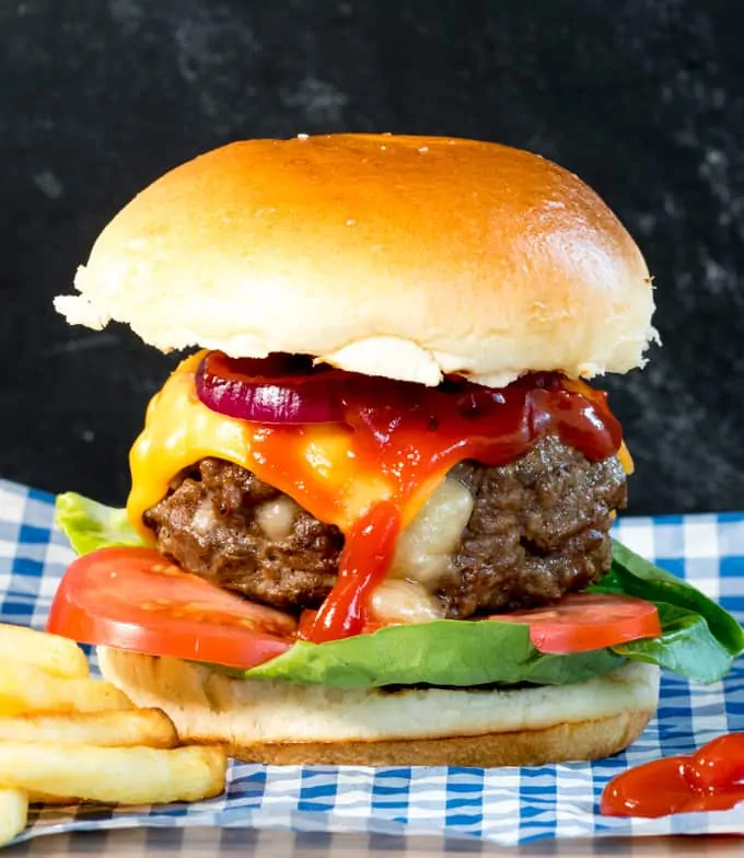 This melty cheese stuffed burger with crunchy lettuce, onion and juicy tomatoes, all sandwiched in a golden toasted brioche bun is way better than any takeout burger!